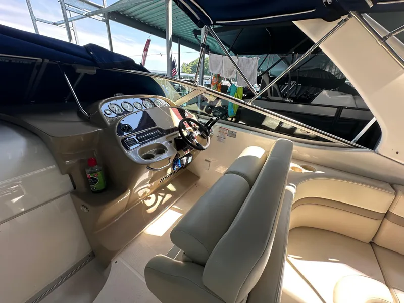 Slide: The Image of 2004 Chaparral Signature 330 boat interior with steering console and seating area. - 9