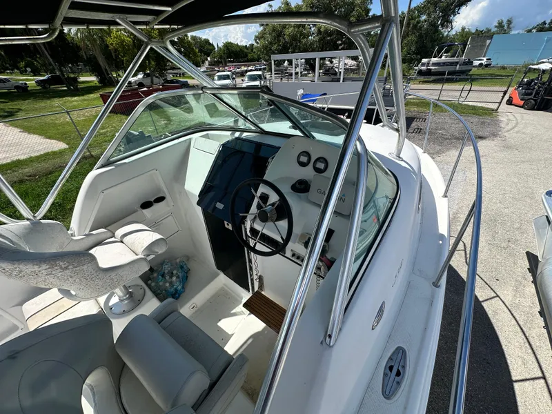 Slide: The Image of 2001 Sailfish 234 WAC boat interior with steering wheel and seating. - 11