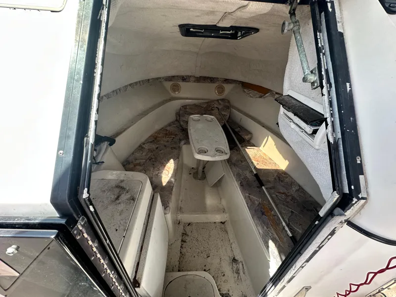 Slide: The Image of 2001 Sailfish 234 WAC cabin interior with seating and storage compartments. - 12