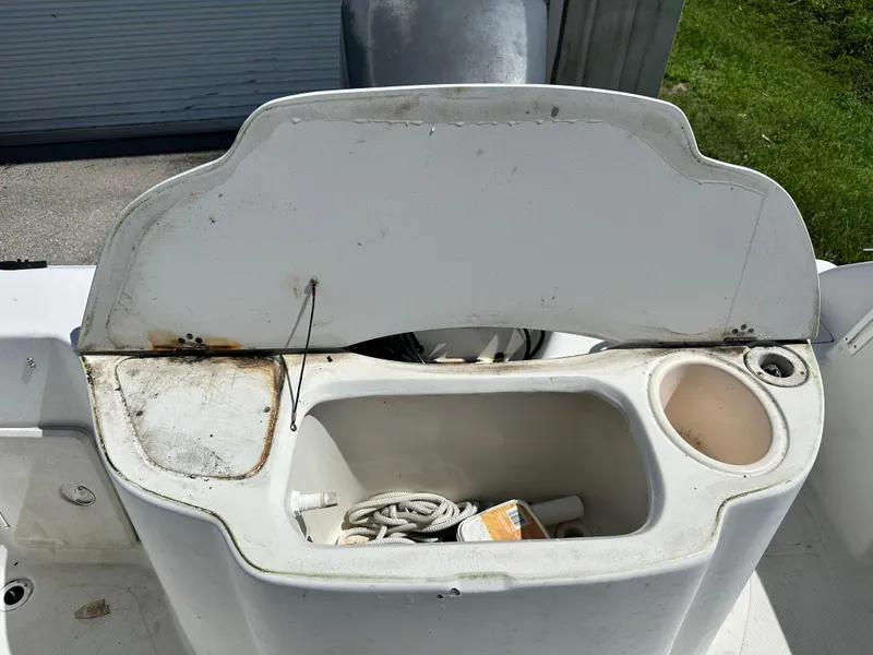 Slide: The Image of Open storage compartment on 2001 Sailfish 234 WAC boat, containing rope and items. - 16