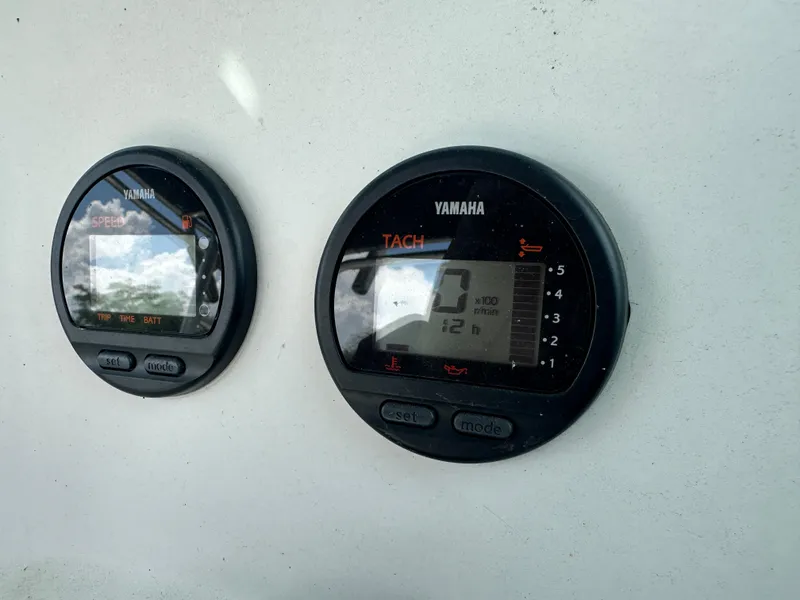 Slide: The Image of Yamaha speed and tachometer gauges on a 2001 Sailfish 234 WAC boat dashboard. - 18