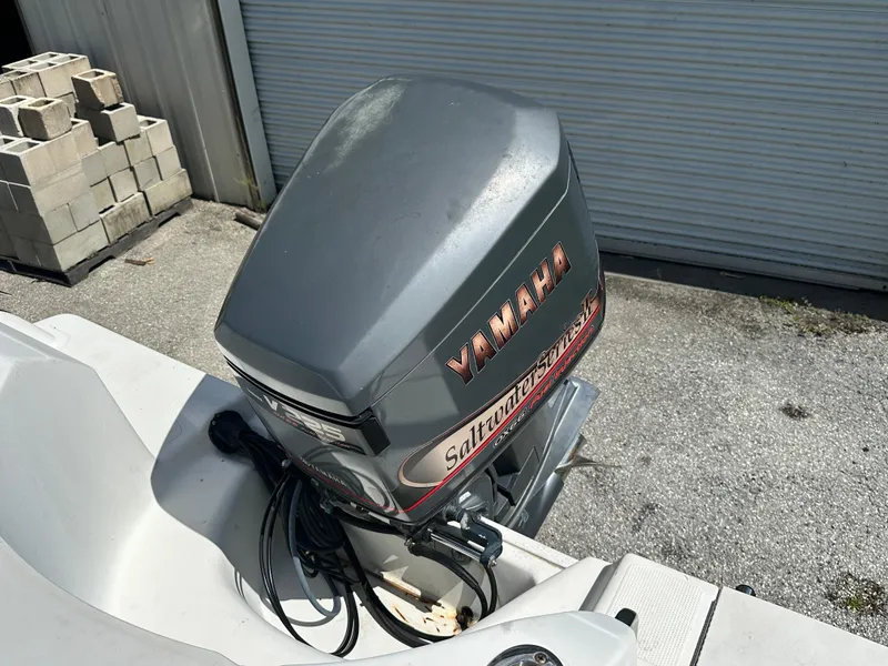 Slide: The Image of Yamaha outboard motor on 2001 Sailfish 234 WAC boat, parked near cinder blocks. - 22