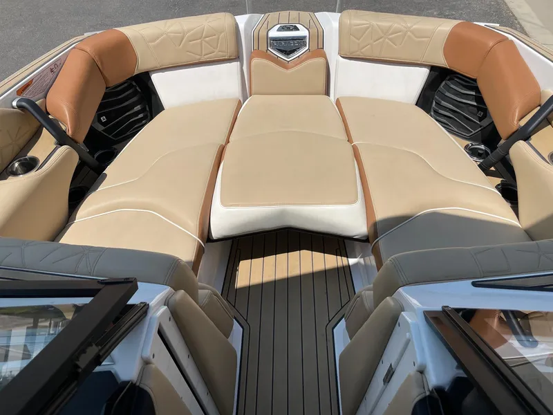 Slide: The Image of 2021 Nautique Super Air Nautique G23 Paragon boat interior with tan leather seating. - 11