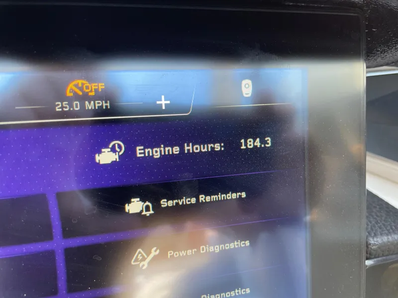 Slide: The Image of Dashboard display of a 2021 Nautique Super Air Nautique G23 Paragon showing 184.3 engine hours. - 13