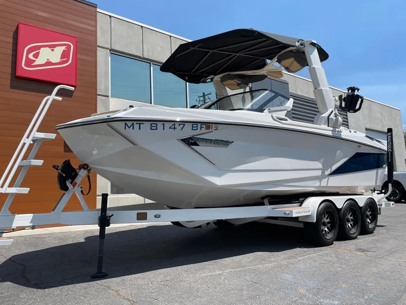Slide: The Image of 2021 Nautique Super Air Nautique G23 Paragon boat on trailer outside dealership. - 2