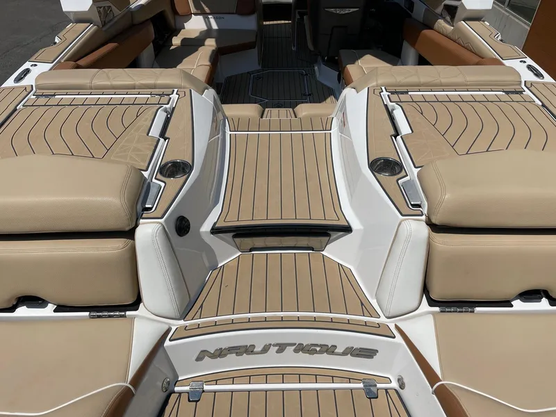 Slide: The Image of 2021 Nautique Super Air Nautique G23 Paragon interior with tan upholstery and sleek design. - 4