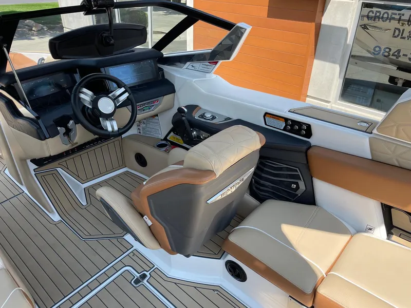 Slide: The Image of 2021 Nautique Super Air Nautique G23 Paragon interior with luxury seating and advanced dashboard. - 6