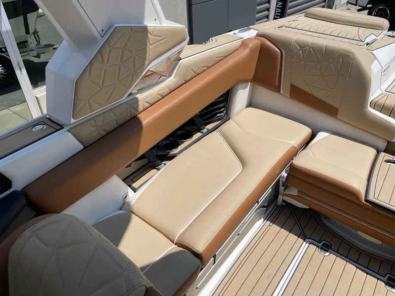Slide: The Image of 2021 Nautique Super Air Nautique G23 Paragon interior with tan and brown seating. - 7