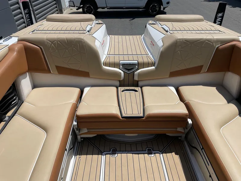 Slide: The Image of 2021 Nautique Super Air Nautique G23 Paragon interior with tan and brown seating. - 8