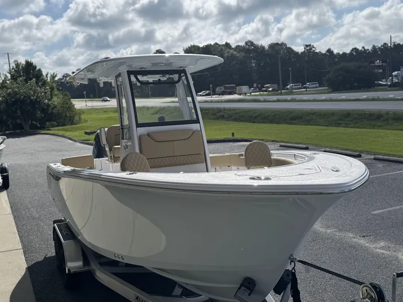 Slide: The Image of 2026 Sportsman Heritage 231 Center Console boat on trailer, parked outdoors. - 10
