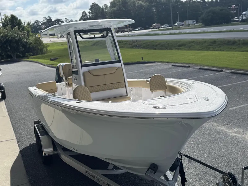 Slide: The Image of 2026 Sportsman Heritage 231 Center Console boat on trailer, parked outdoors. - 11