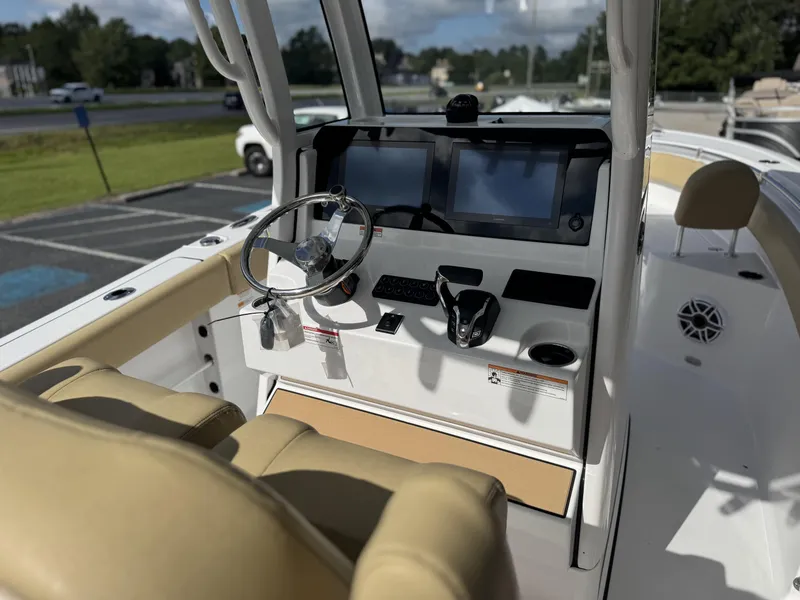 Slide: The Image of 2026 Sportsman Heritage 231 Center Console boat interior with steering wheel and dual screens. - 13