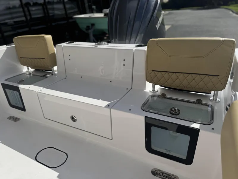 Slide: The Image of 2026 Sportsman Heritage 231 Center Console boat interior with tan seats and storage compartments. - 16