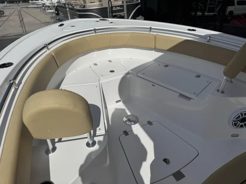 Slide: The Image of 2026 Sportsman Heritage 231 Center Console boat interior with beige seating and storage compartments. - 18
