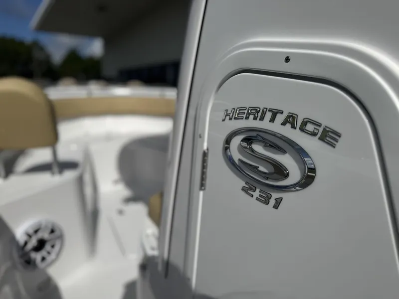 Slide: The Image of 2026 Sportsman Heritage 231 Center Console boat, close-up of logo and seating area. - 19