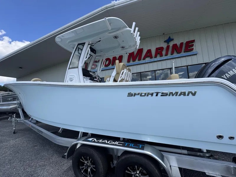 Slide: The Image of 2026 Sportsman Heritage 231 Center Console boat on trailer outside showroom. - 2