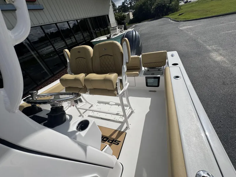 Slide: The Image of 2026 Sportsman Heritage 231 Center Console boat interior with tan seating and steering wheel. - 24