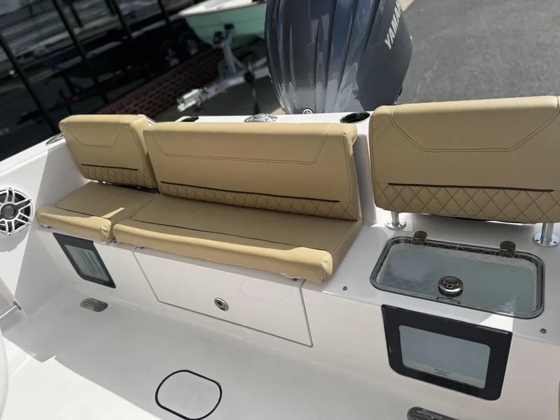 Slide: The Image of 2026 Sportsman Heritage 231 Center Console boat with tan seating and storage compartments. - 26