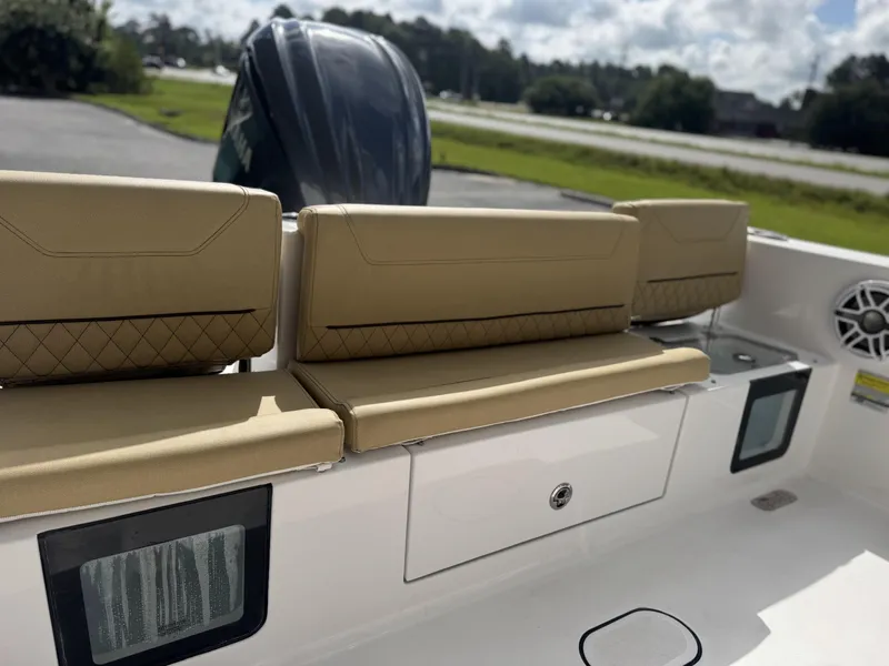 Slide: The Image of 2026 Sportsman Heritage 231 Center Console boat with tan seating and storage compartments. - 27
