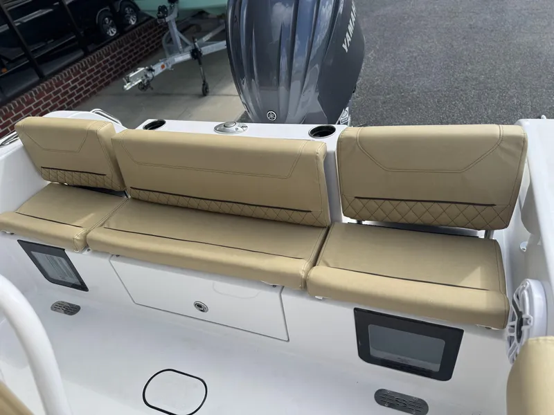 Slide: The Image of 2026 Sportsman Heritage 231 Center Console boat with beige seating and Yamaha engine. - 29