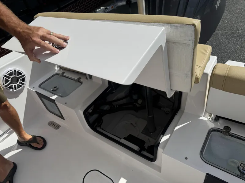 Slide: The Image of 2026 Sportsman Heritage 231 Center Console boat interior with storage compartment open. - 30