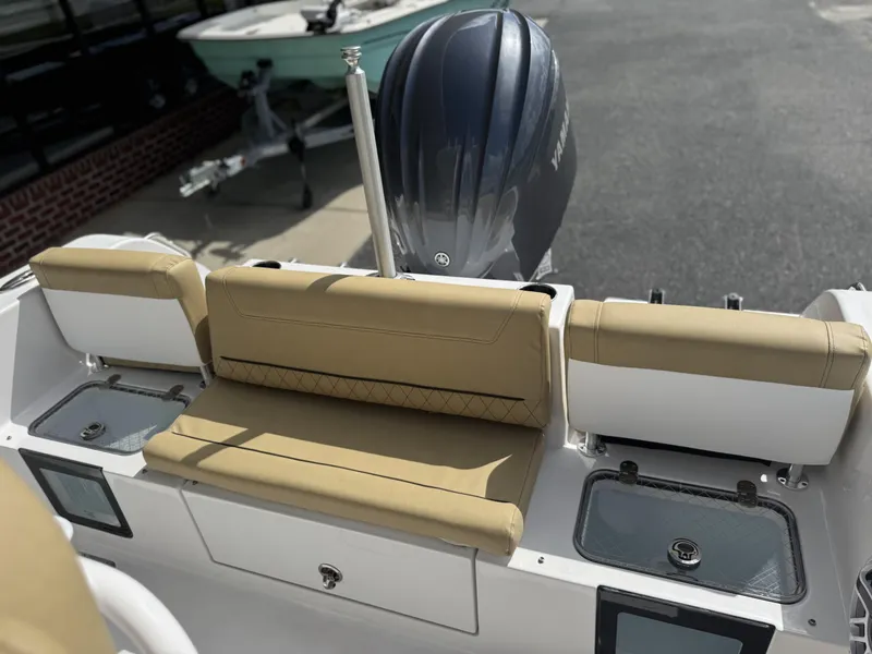 Slide: The Image of 2026 Sportsman Heritage 231 Center Console boat with tan seating and Yamaha engine. - 34