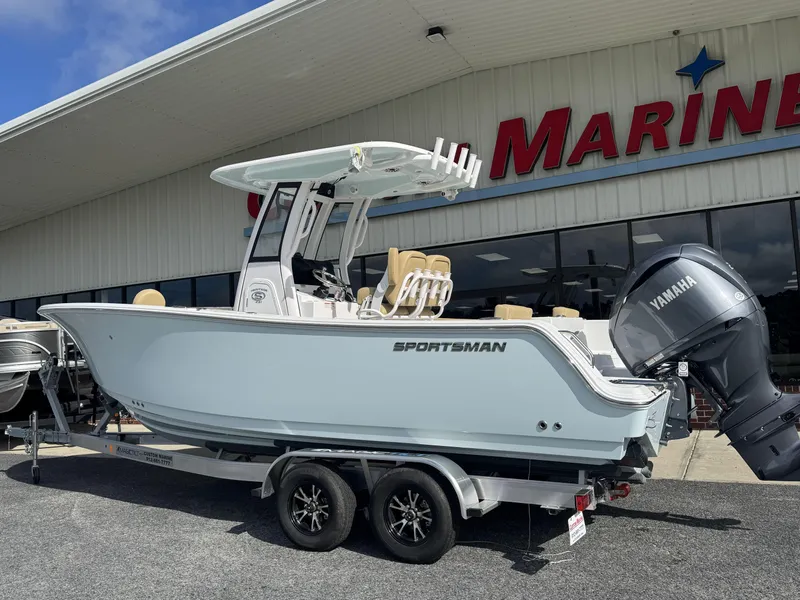 Slide: The Image of 2026 Sportsman Heritage 231 Center Console boat on trailer outside marine dealership. - 4