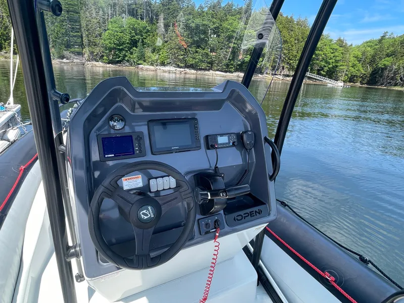 Slide: The Image of 2022 Zodiac Open 7 boat console with steering wheel and navigation equipment. - 16