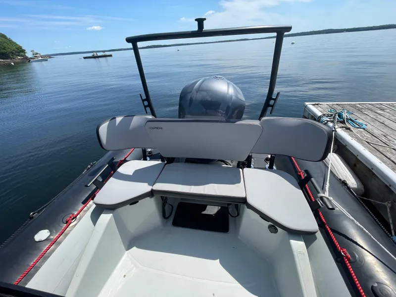 Slide: The Image of 2022 Zodiac Open 7 boat docked on calm water, featuring spacious seating. - 21