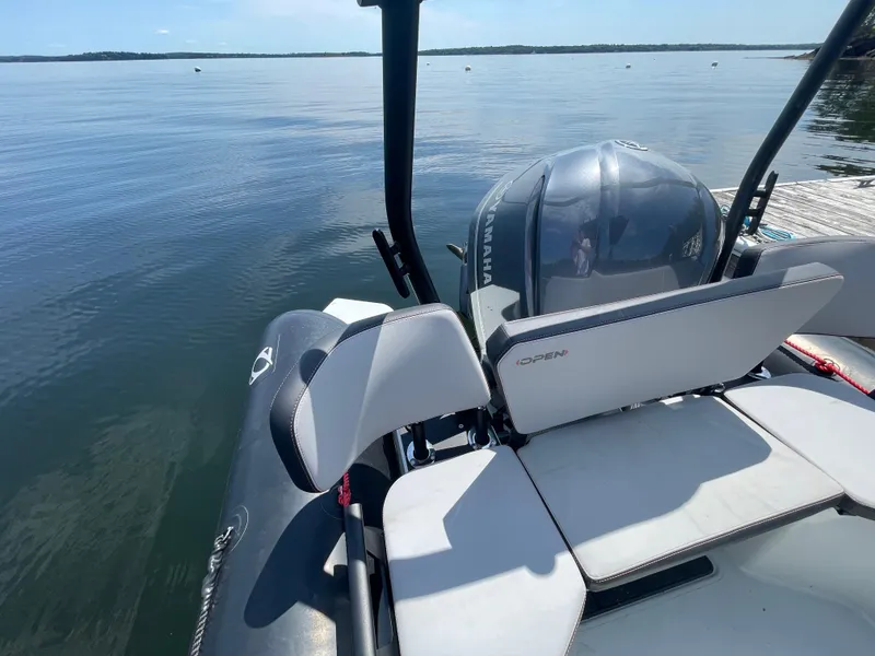 Slide: The Image of 2022 Zodiac Open 7 boat with Yamaha engine docked on calm water. - 22