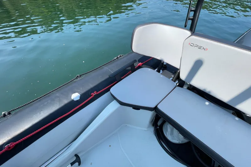 Slide: The Image of 2022 Zodiac Open 7 boat interior with seating, on calm water. - 26