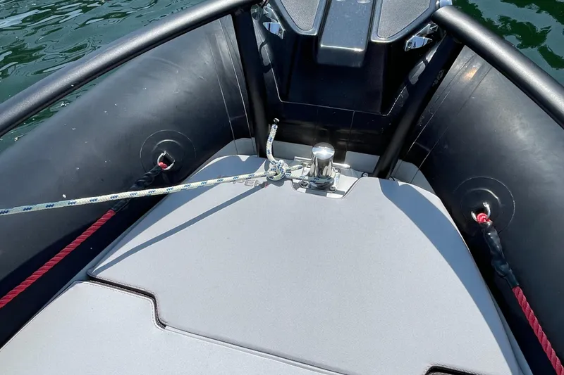 Slide: The Image of 2022 Zodiac Open 7 boat bow with ropes and cleat on water. - 35
