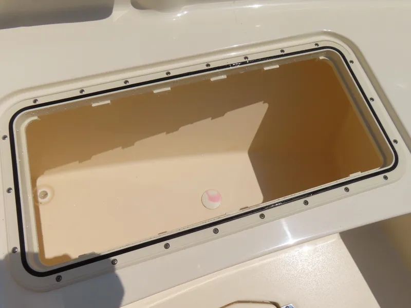 Slide: The Image of Storage compartment on a 2022 Scout 255 Dorado boat, open and empty. - 10