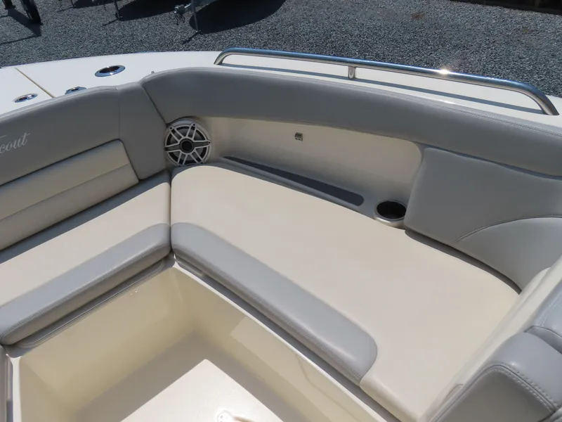 Slide: The Image of 2022 Scout 255 Dorado boat interior with cushioned seating and speaker. - 11