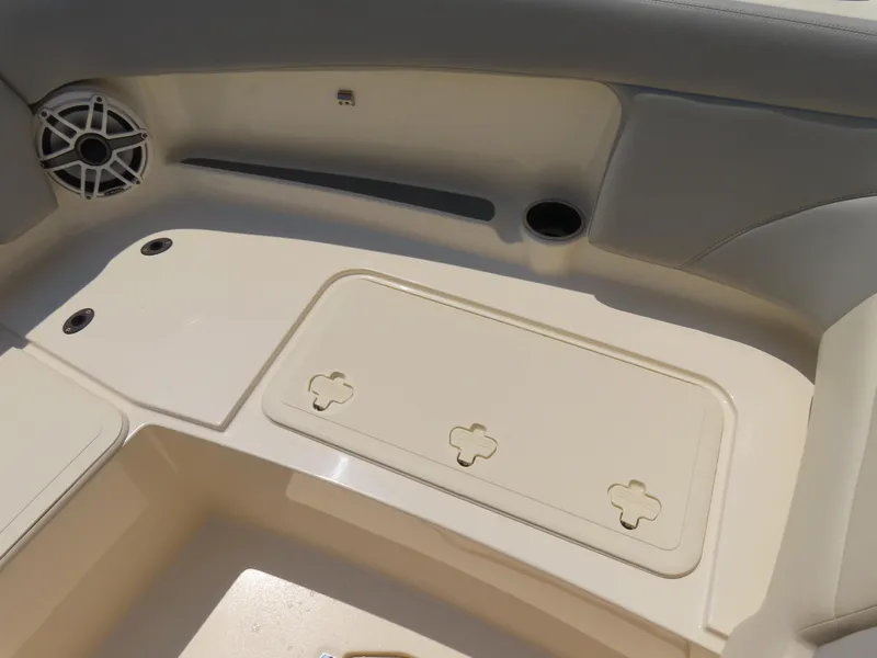 Slide: The Image of 2022 Scout 255 Dorado boat interior with storage compartment and speaker. - 12