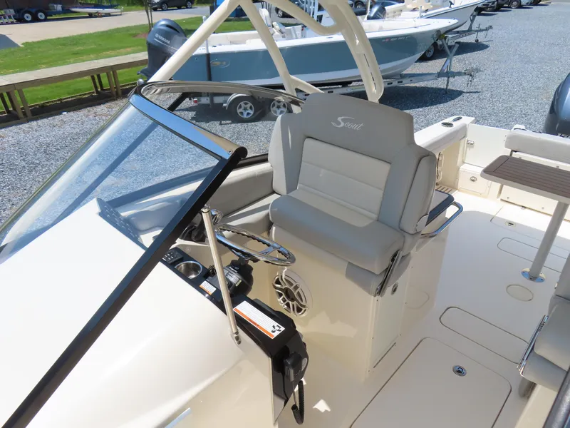 Slide: The Image of 2022 Scout 255 Dorado boat interior with helm seat and steering wheel. - 26