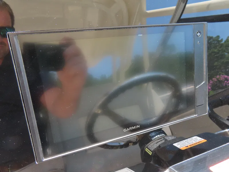 Slide: The Image of Garmin display on 2022 Scout 255 Dorado boat dashboard, reflecting surroundings. - 28
