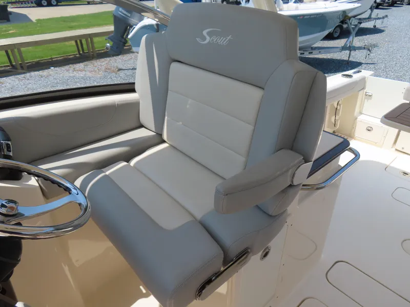 Slide: The Image of 2022 Scout 255 Dorado boat interior with luxurious seating and steering wheel. - 31