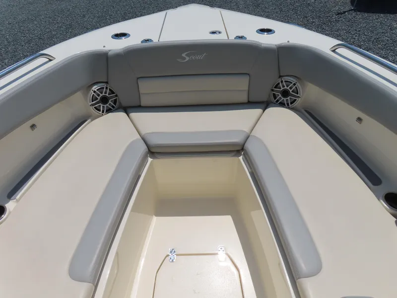 Slide: The Image of 2022 Scout 255 Dorado boat interior with cushioned seating and speakers. - 7