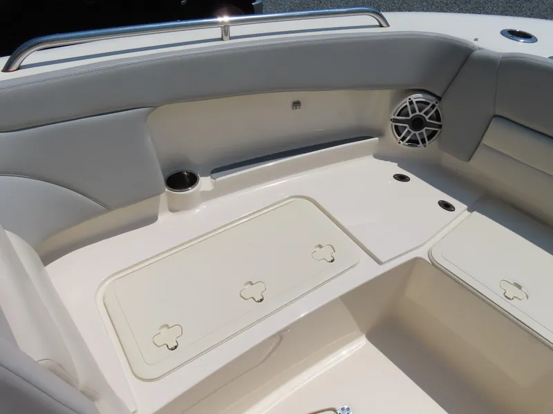 Slide: The Image of 2022 Scout 255 Dorado boat interior with seating, storage, and speaker. - 9