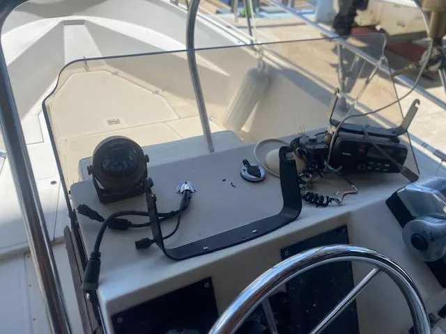 Slide: The Image of Boat trailer for 1989 Boston Whaler 21 Outrage parked on driveway. - 10