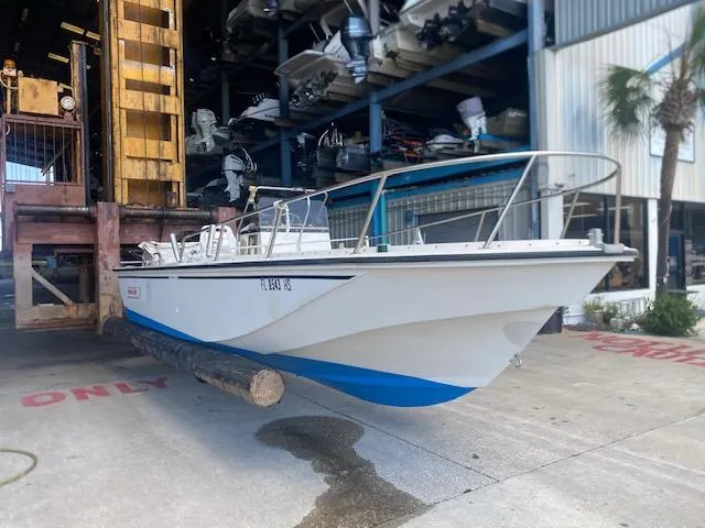 Slide: The Image of 1989 Boston Whaler 20 Outrage boat in storage facility, side view. - 21