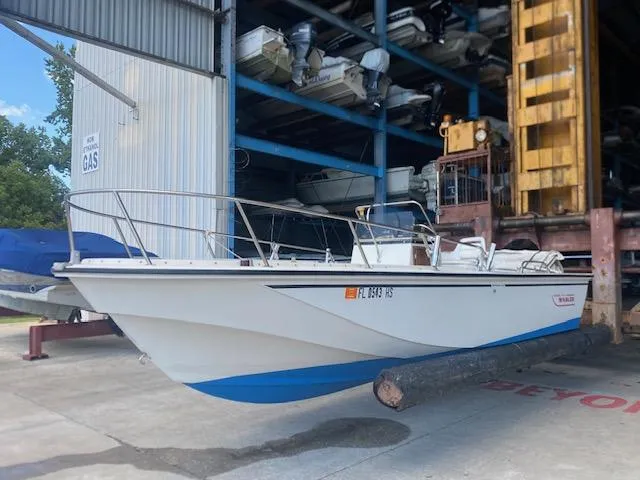 Slide: The Image of 1989 Boston Whaler 20 Outrage boat in storage facility, side view. - 22