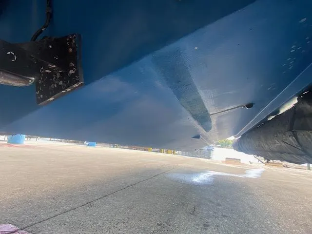 Slide: The Image of Bottom view of a 1989 Boston Whaler 20 Outrage boat on dry dock. - 26