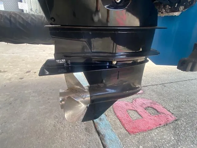 Slide: The Image of Outboard motor propeller of a 1989 Boston Whaler 20 Outrage boat on concrete surface. - 27