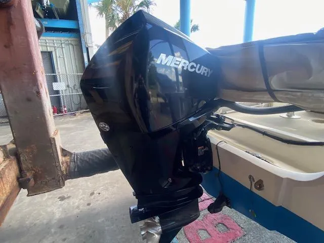 Slide: The Image of 1989 Boston Whaler 20 Outrage with Mercury outboard motor, docked outdoors. - 28