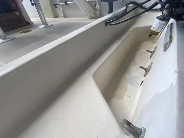 Slide: The Image of 1989 Boston Whaler 20 Outrage boat interior, showcasing seating and storage compartments. - 34