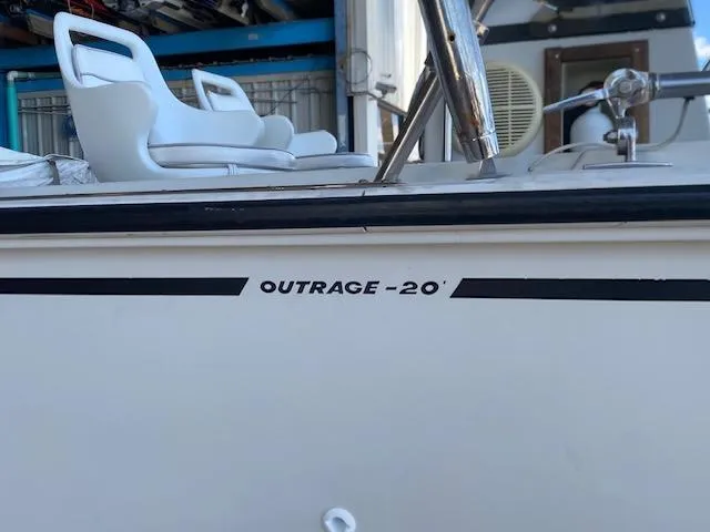 Slide: The Image of 1989 Boston Whaler 20 Outrage boat with white seating and visible model name on the side. - 36
