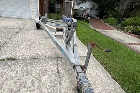 Slide: The Image of Trailer for 1989 Boston Whaler 21 Outrage, parked on a driveway near a house. - 9