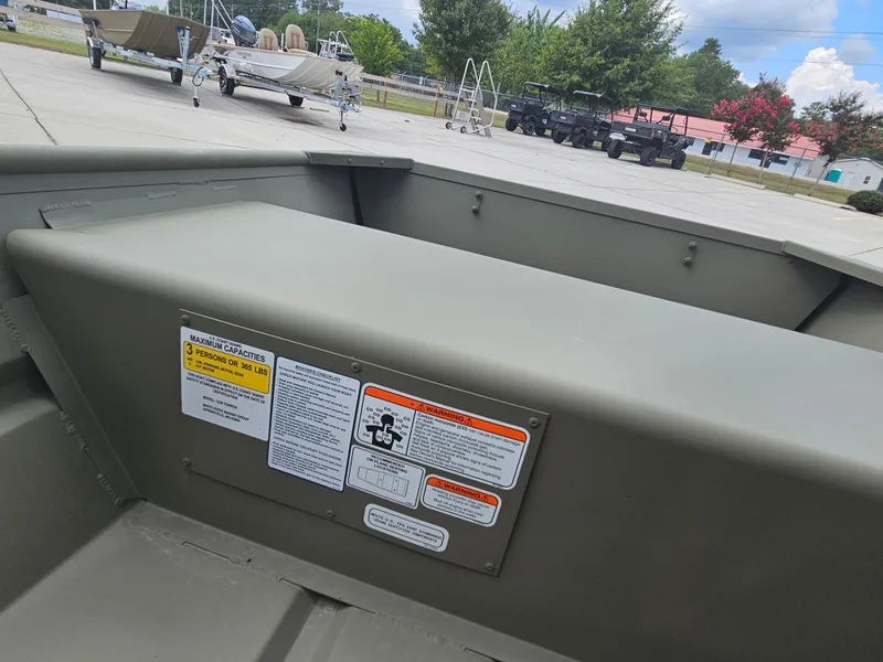 Slide: The Image of 2026 Tracker Grizzly 1236 Jon boat interior with capacity warning labels. - 4